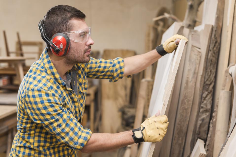 Expert door installer working with wooden frame