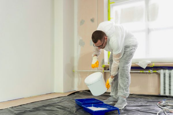 Painter mixing fresh color for interior living room wall