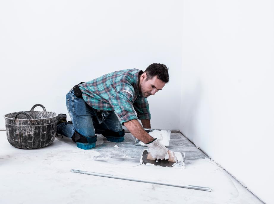 Drywall technician preparing tools for wall repair