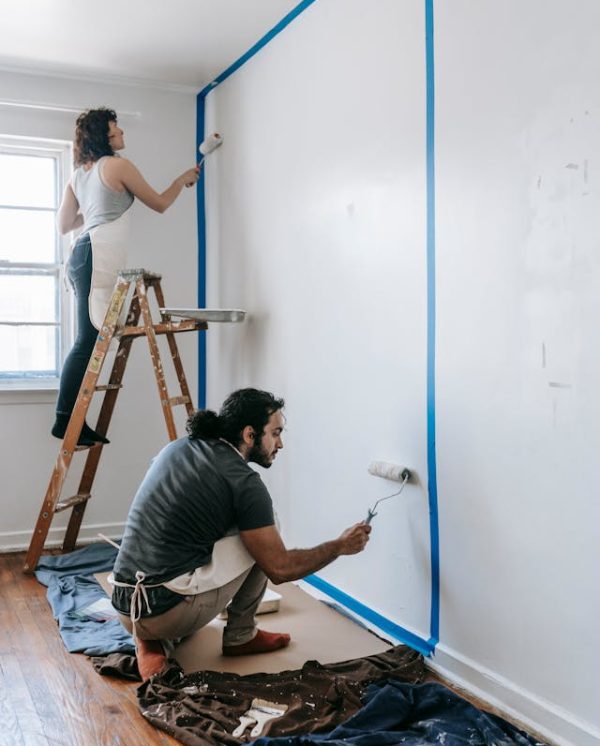 Expert Wall Painting Services by Malik Renovation Home renovation worker painting an interior wall